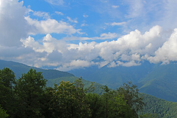 Beautiful scenery clouds over mountains sunny day