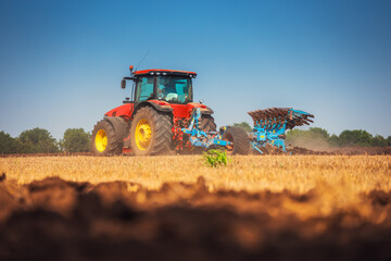 Obraz premium Tractor plowing the fields