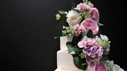 White wedding cake with flowers, roses