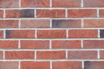 Vintage stained red brick wall close up texture background 