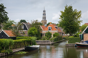 Scenic corner of the Dutch city of Hindelopen with a church in the background