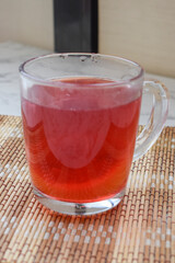 Compote in mug, red vitamin drink, vertical photo