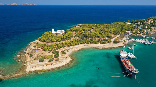 Aerial drone bird's eye view photo of picturesque neoclassic houses in historic and traditional island of Spetses with emerald clear waters, Saronic Gulf, Greece