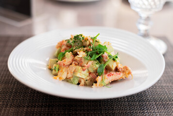 Fusion of Mexican cuisine and a traditional seafood crab salad. Closeup of Blood Orange Crab Posole Salad with fresh cooked Dungeness crab meat, avocado, radish, Romaine lettuce, and white hominy.
