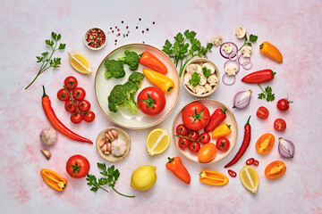 Tomato, spices, bell chili pepper, onion. Vegan diet food, creative composition on marble. Cherry tomatoes, bell pepper, broccoli, champignons layout, cooking colorful concept, top view.