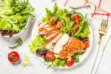 Grilled chicken with fresh salad at table.