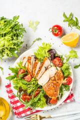 Grilled chicken with fresh salad at table.