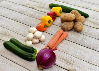 Fresh wholesome vegetarian ingredients of organic vegetables arranged in simplistic and artistic knolling pattern to show attractive healthy ingredients