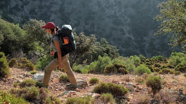 Young woman with backpack walk the Lycian way hiking trail in Turkey.
