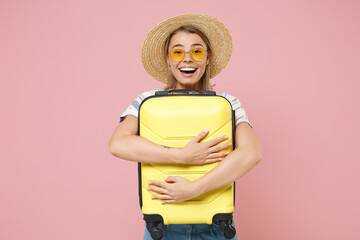 Excited traveler tourist girl in striped shirt glasses hat isolated on pink wall background....