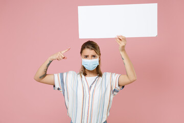 Young girl in casual striped shirt sterile face mask isolated on pink background. Epidemic pandemic...