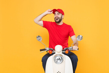 Delivery man in red cap t-shirt uniform driving moped motorbike scooter isolated on yellow...