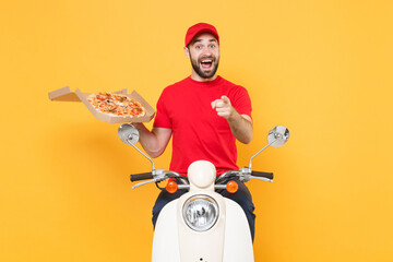Delivery man in red cap t-shirt uniform driving moped motorbike scooter hold pizza in cardboard flatbox isolated on yellow background studio Fun guy employee working courier Service quarantine concept