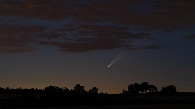 Adersbach, Germany - July 11, 2020: Comet C/2020 F3 (Neowise) moving low over the horizon, about 1 hour after sunset.