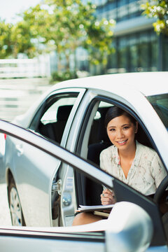 Smiling businesswoman sitting in car