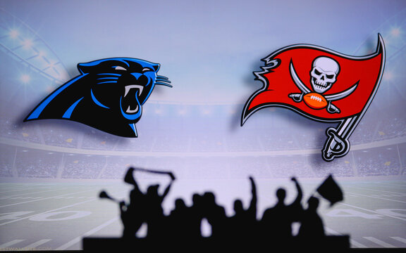 Carolina Panthers vs. Tampa Bay Buccaneers. Fans support on NFL Game. Silhouette of supporters, big screen with two rivals in background.