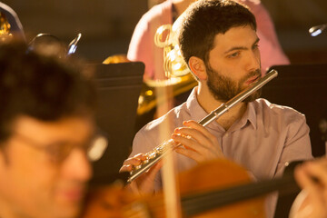 Flutist performing in orchestra