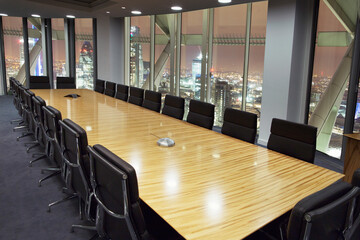 Empty conference room overlooking London at night, London, United Kingdom