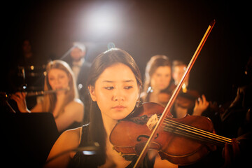 Violinist performing in orchestra