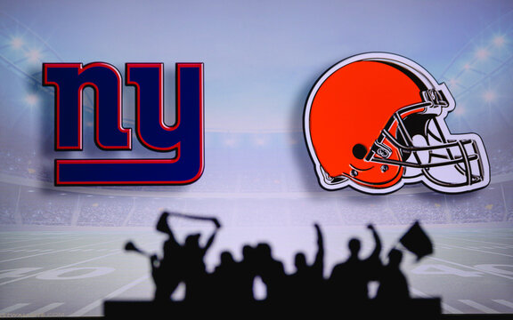 New York Giants vs. Cleveland Browns. Fans support on NFL Game. Silhouette of supporters, big screen with two rivals in background.