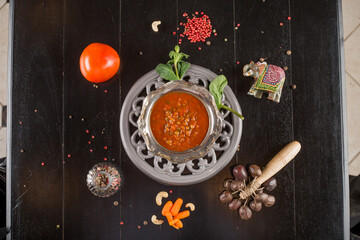 spicy mexican bean tomato soup on a wooden table