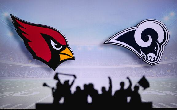 Arizona Cardinals vs. Baltimore Ravens. Fans support on NFL Game. Silhouette of supporters, big screen with two rivals in background.