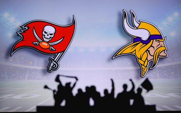 Tampa Bay Buccaneers vs. Minnesota Vikings. Fans support on NFL Game. Silhouette of supporters, big screen with two rivals in background.