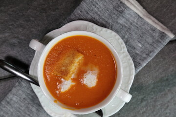 Homemade Tomato carrot soup in a bow made with frsh Tomatoes.