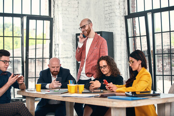 Business meeting in an office, the businesspeople are discussing a document