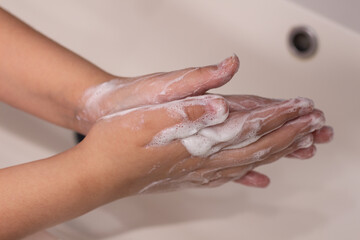 woman washing hands in bathroom