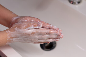 Fototapeta premium woman washing hands in bathroom
