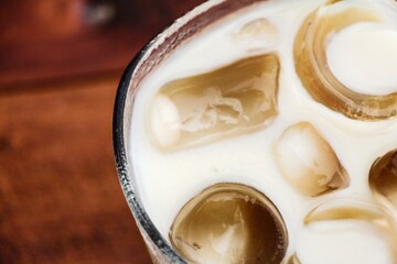 Ice cubes floating in a milk drink