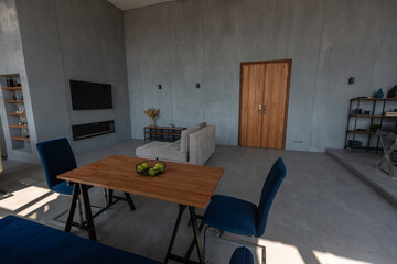 Modern minimalistic dark gray loft style studio apartment interior design. kitchen, sitting area, workplace, shower and bath. bright sun rays inside.