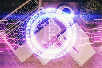 Blockchain theme hologram drawings over computer on the desktop background. Top view. Double exposure.