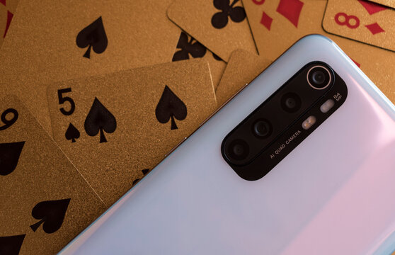 smartphone with golden poker cards