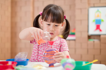 toddler girl making sand animal crafts for homeschooling