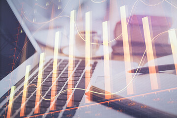 Double exposure of financial chart drawing and desktop with coffee and items on table background. Concept of forex market trading