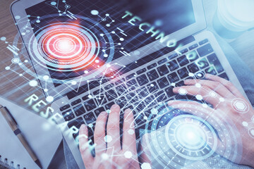 Multi exposure of man's hands typing over computer keyboard and data theme hologram drawing. Top view. Technology concept.