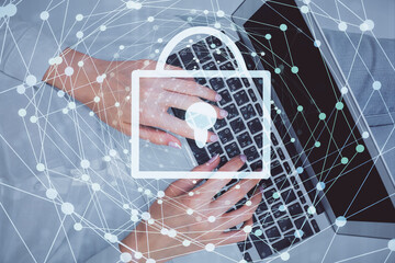 Double exposure of woman hands working on computer and lock hologram drawing. Top View. Security concept.
