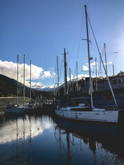 Boats in the Puerto Williams yacht club in a beautiful day with blue sky and clouds, Chilean Patagonia