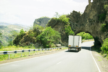 truck drives on an asphalt road in the mountains