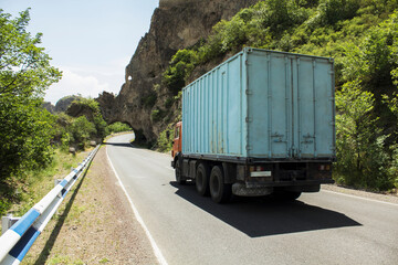 truck drives on an asphalt road in the mountains