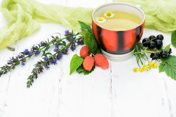 hot tea on a wooden white background, the ingredients for the preparation of natural herbal tea....