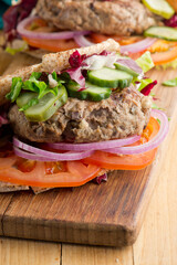 Hamburger made with lamb meat. Lamb burger. Classic traditional greek variation of the classic american burger tradition. seasoned lamb meat with feta cheese, red onion and greek mayo. 