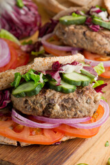 Hamburger made with lamb meat. Lamb burger. Classic traditional greek variation of the classic american burger tradition. seasoned lamb meat with feta cheese, red onion and greek mayo. 