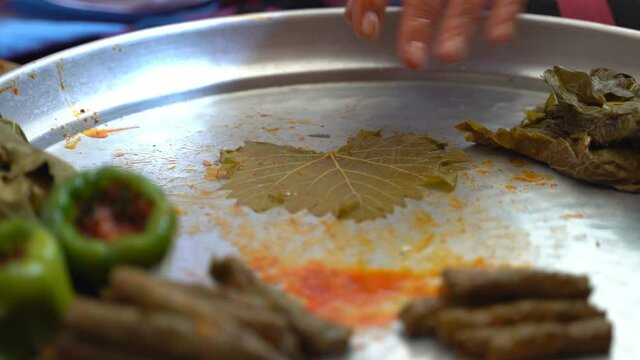 A woman is preparing stuffed grape leaves, leaf wrap, Turkish food culture and stuffed leaves