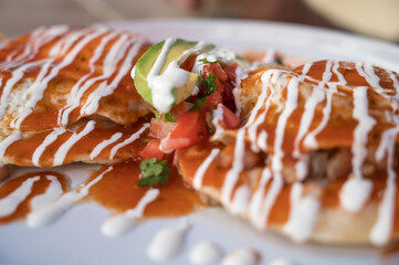 Mexican tostadas with chicken and spicy chili sauce