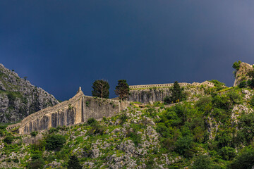 Fototapeta premium View onto Saint John Mountain with the ancient fortified city walls surrounding Old Town of Kotor, Montenegro