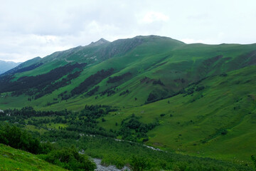 Summer mountains green grass and blue sky landscape. Caucasus mountains