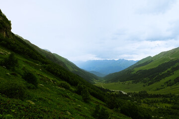 Summer mountains green grass and blue sky landscape. Caucasus mountains